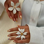 White flower adjustable ring with gold-tone outline and sparkling center