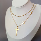 Double-layer gold cross pendant necklace with two hanging gold cross charms