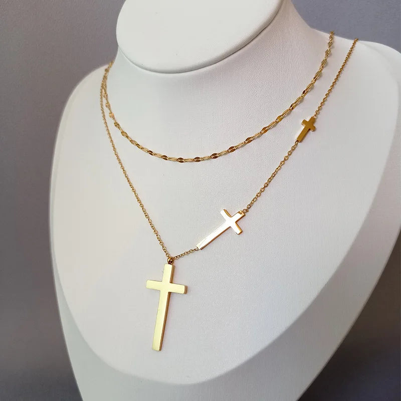 Double-layer gold cross pendant necklace with two hanging gold cross charms