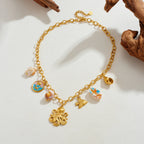 Gold-tone shell charm bracelet-style necklace with octopus pendant and fish enamel charm.