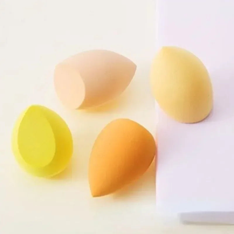 4-piece makeup sponge set with yellow, orange, and pale peach teardrop sponges