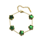 Gold flower bracelet with green enamel clover charms and spring clasp