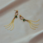 Gold-tone chandelier earrings with green square accents and layered long tassel chains