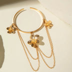 Gold four-petal flower upper arm bracelet with dangling chains and flower drops