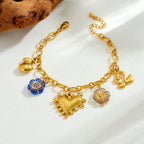 Gold-tone multi-pendant bracelet-style necklace with blue flower charm and heart center charm