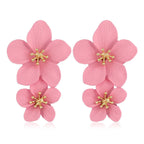 Pink double-flower dangle earrings with gold-tone star accents