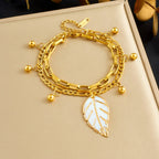 Gold double-layer chain bracelet with leaf pendant and round bead accents