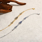 Evil eye bracelet pair in gold and silver-tone with blue oval centers and pavé stones