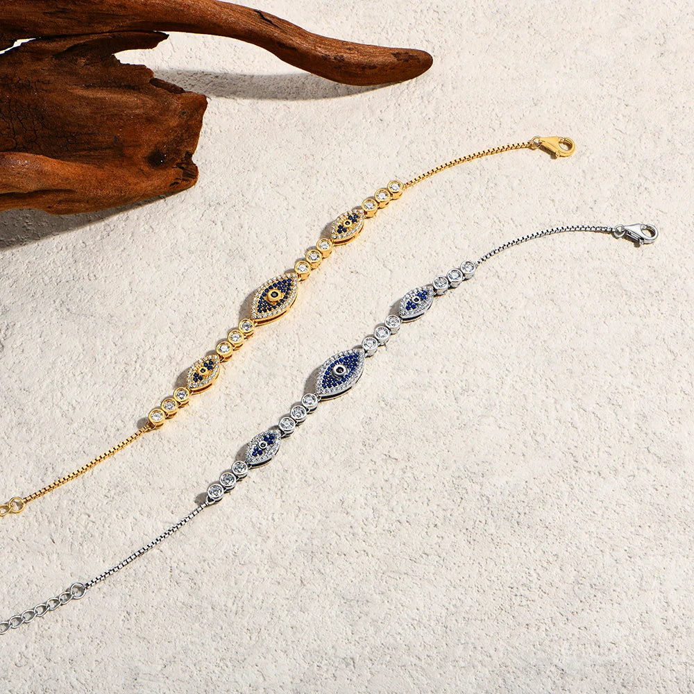 Evil eye bracelet pair in gold and silver-tone with blue oval centers and pavé stones