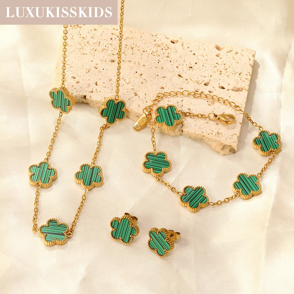 Gold-tone clover jewelry set with green enamel necklace, bracelet, and stud earrings