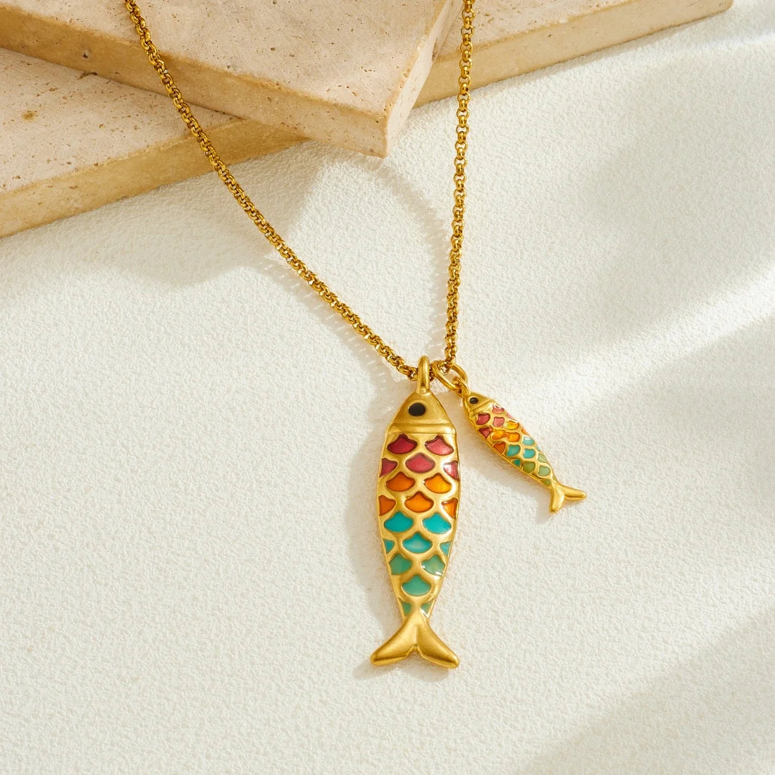 Gold chain ocean fish pendant with two stacked multicolor enamel fish charms