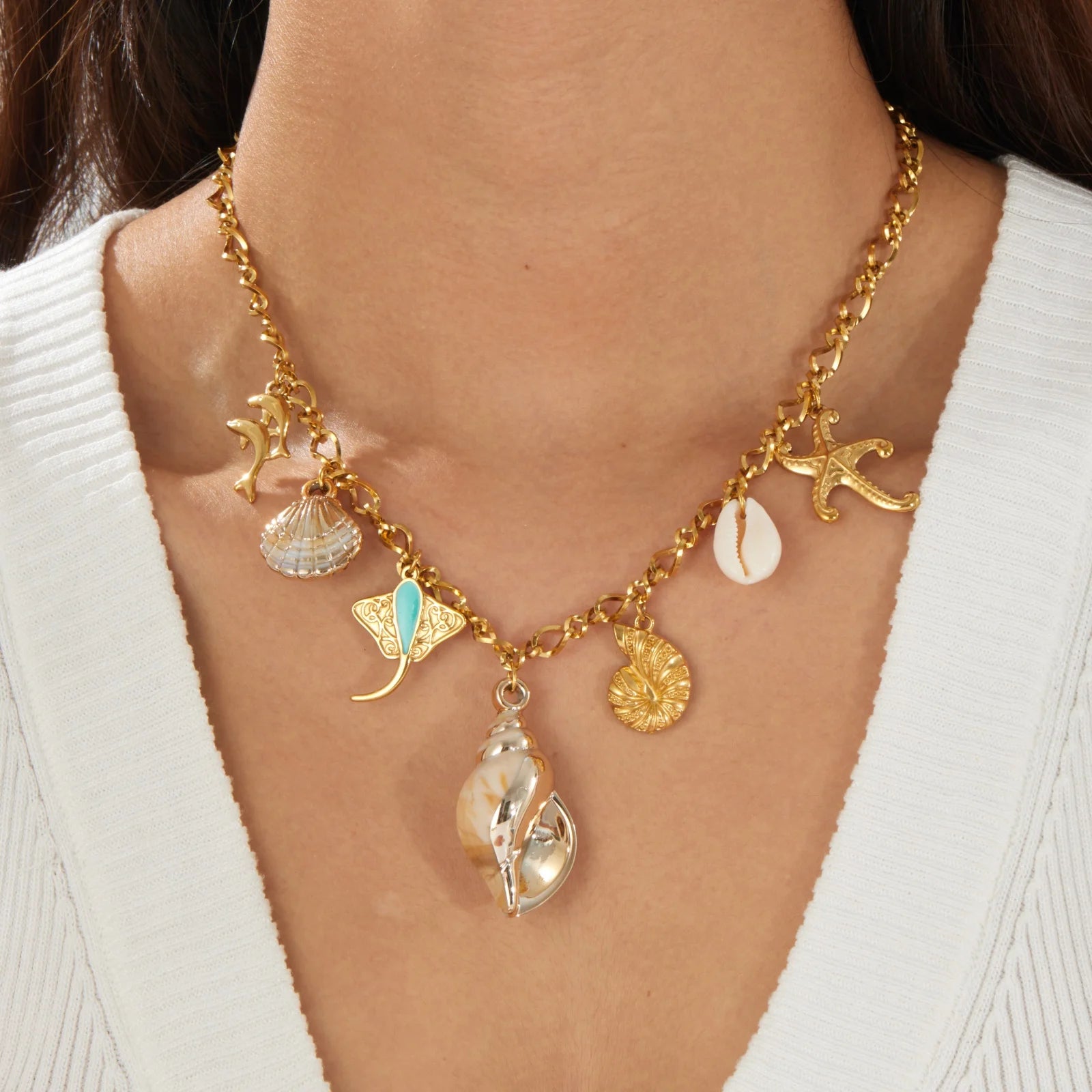 Gold-tone multi-pendant ocean necklace with starfish, seashells, and seahorse charms