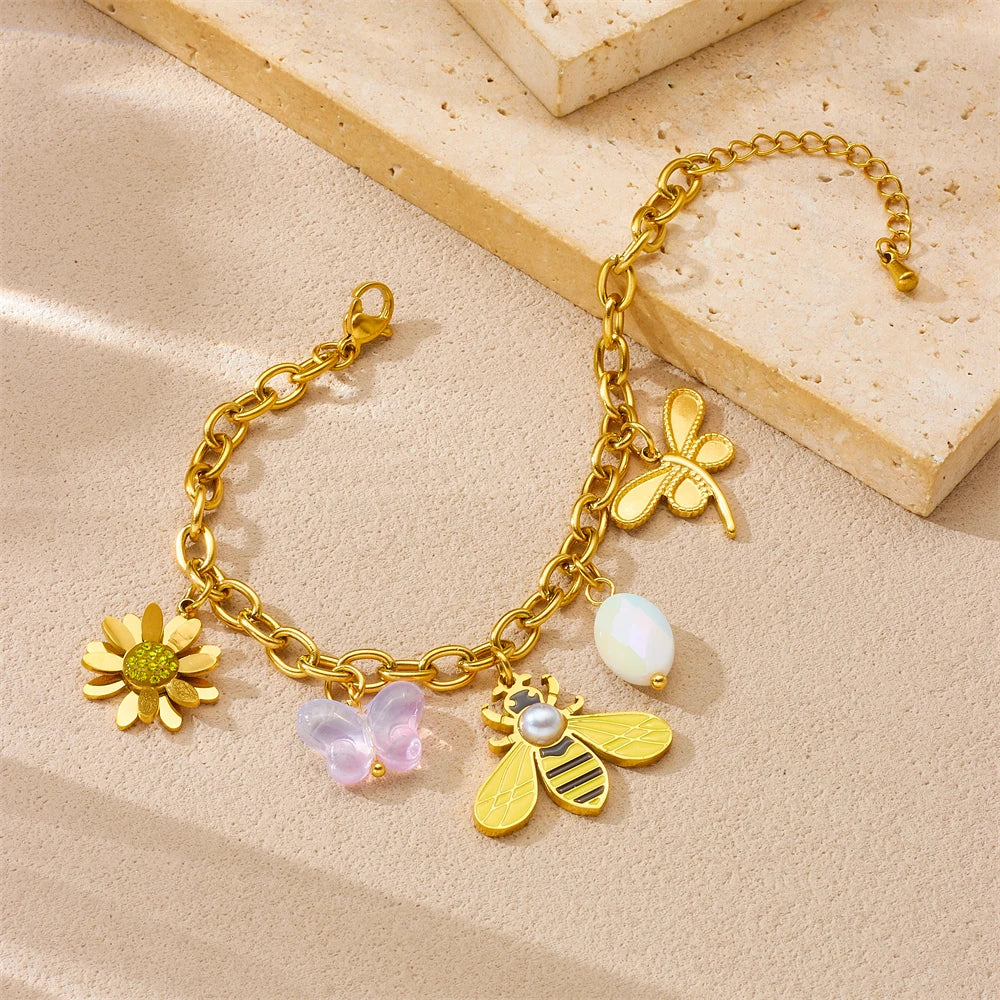 Gold-tone bee and flower charm bracelet with pearl and pastel dangle charms