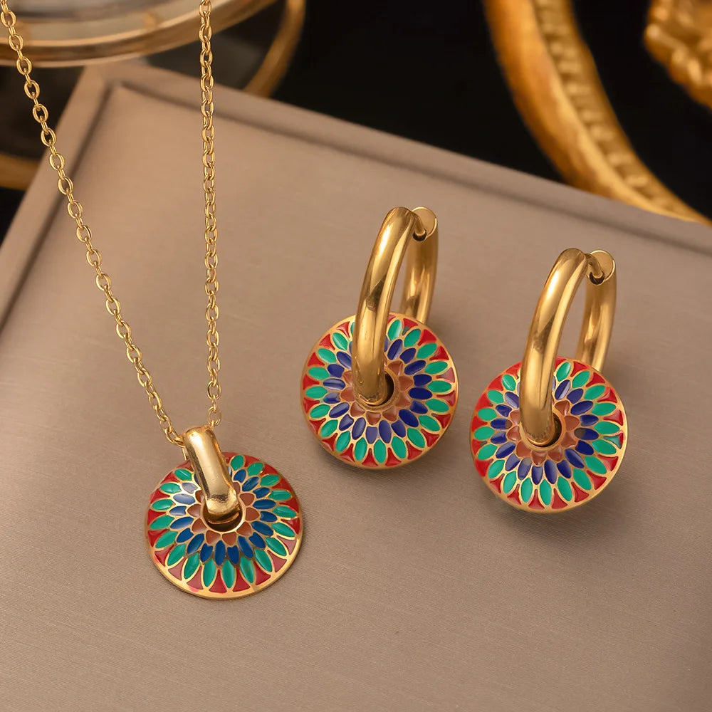 Gold-tone hoop earrings with colorful painted flower disc pendants