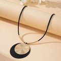 Round dangle earring with black textured disc and gold-tone layered disc