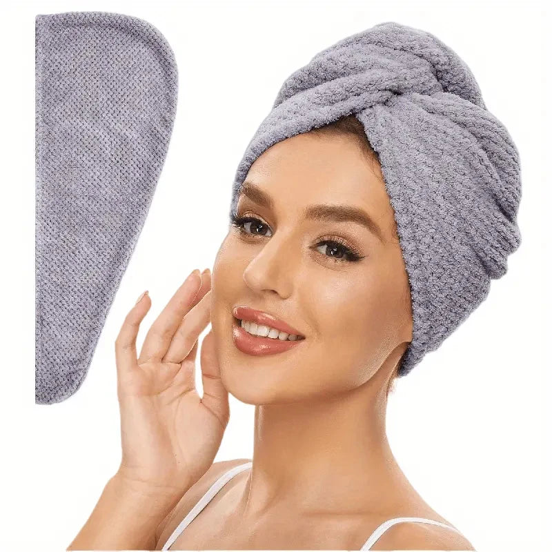 Grey absorbent hair towel wrap on head with rolled turban and side hanging tail