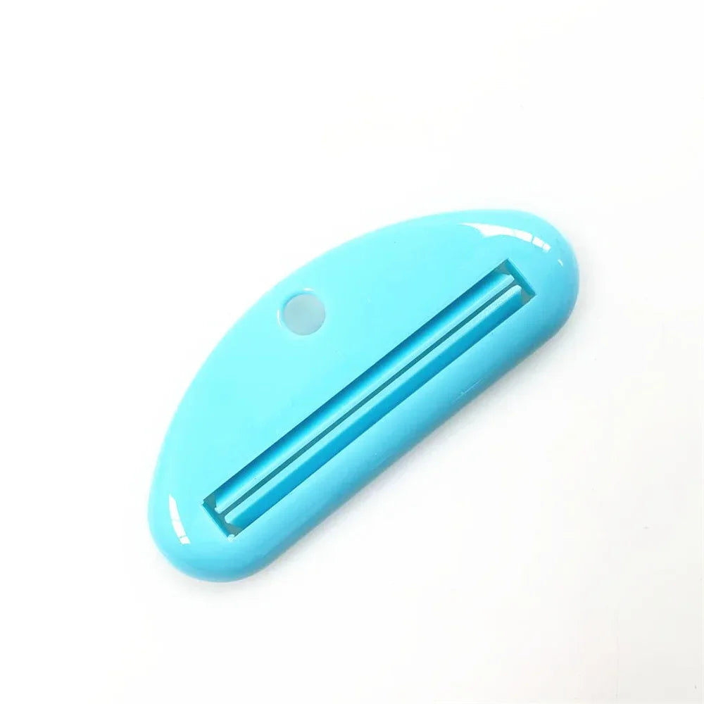 Turquoise toothpaste tube squeezer dispenser with metal channel and round hanging hole