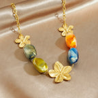 Gold-tone chain necklace with flower charms and orange, blue, green resin beads