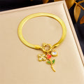 Gold-tone rose flower pendant necklace and bracelet set with red enamel, clear stones
