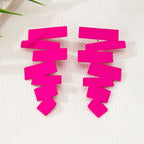 Geometric stud earrings in hot pink with stacked zigzag shapes and pointed ends