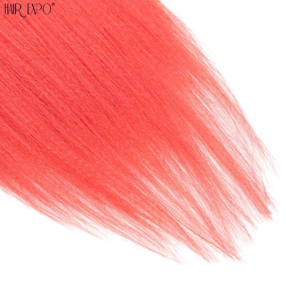Red synthetic braiding hair strands with lighter tips, close-up