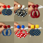 Drop earrings with red ball tops and blue polka-dot disc drops with dangling hooks