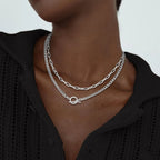 Silver layered chain necklace with oval connector; Cuban link and paperclip links