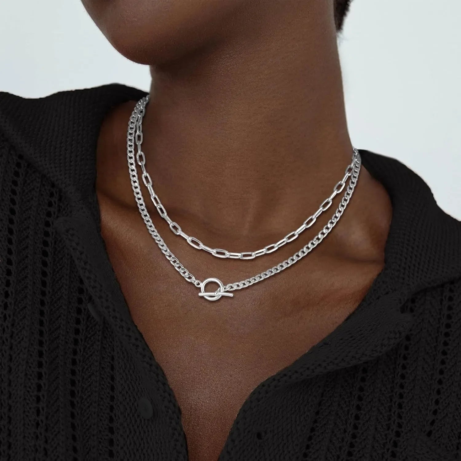 Silver layered chain necklace with oval connector; Cuban link and paperclip links