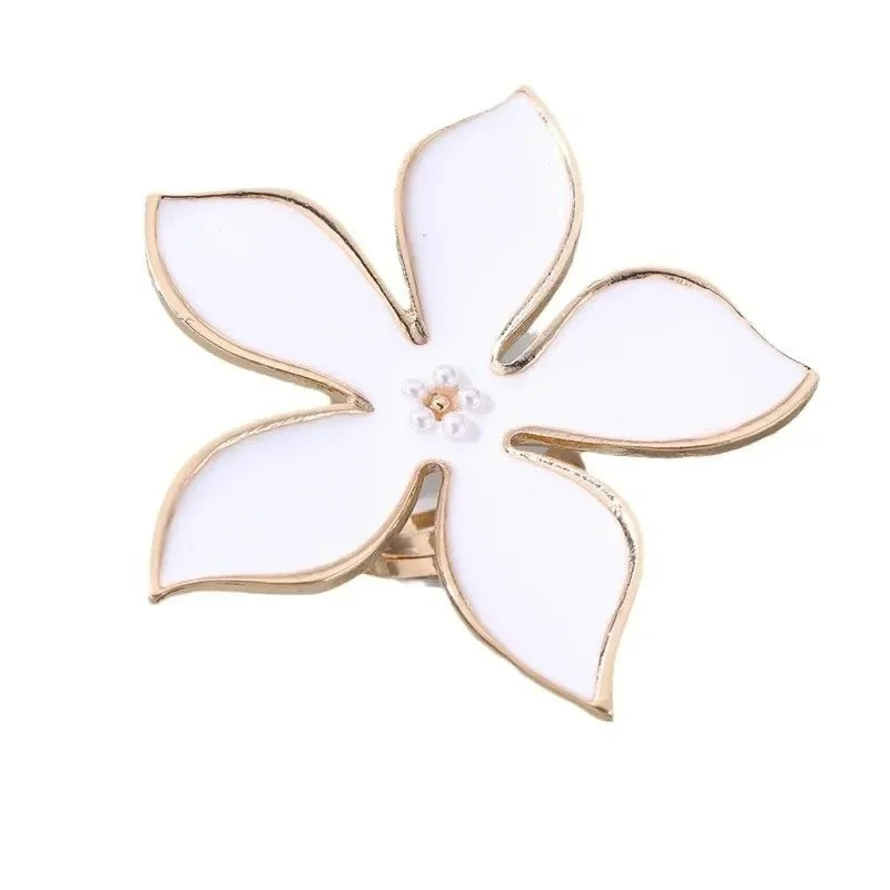 White flower adjustable ring with five white petal shapes and gold-tone band
