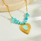 Gold-tone heart pendant necklace with turquoise bar beads and blue enamel-style heart.