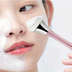 Facial blackhead removal tool with pink handle scraping nose during skincare