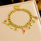 Watermelon enamel charm necklace on box, gold-tone chain with red-green watermelon pendants