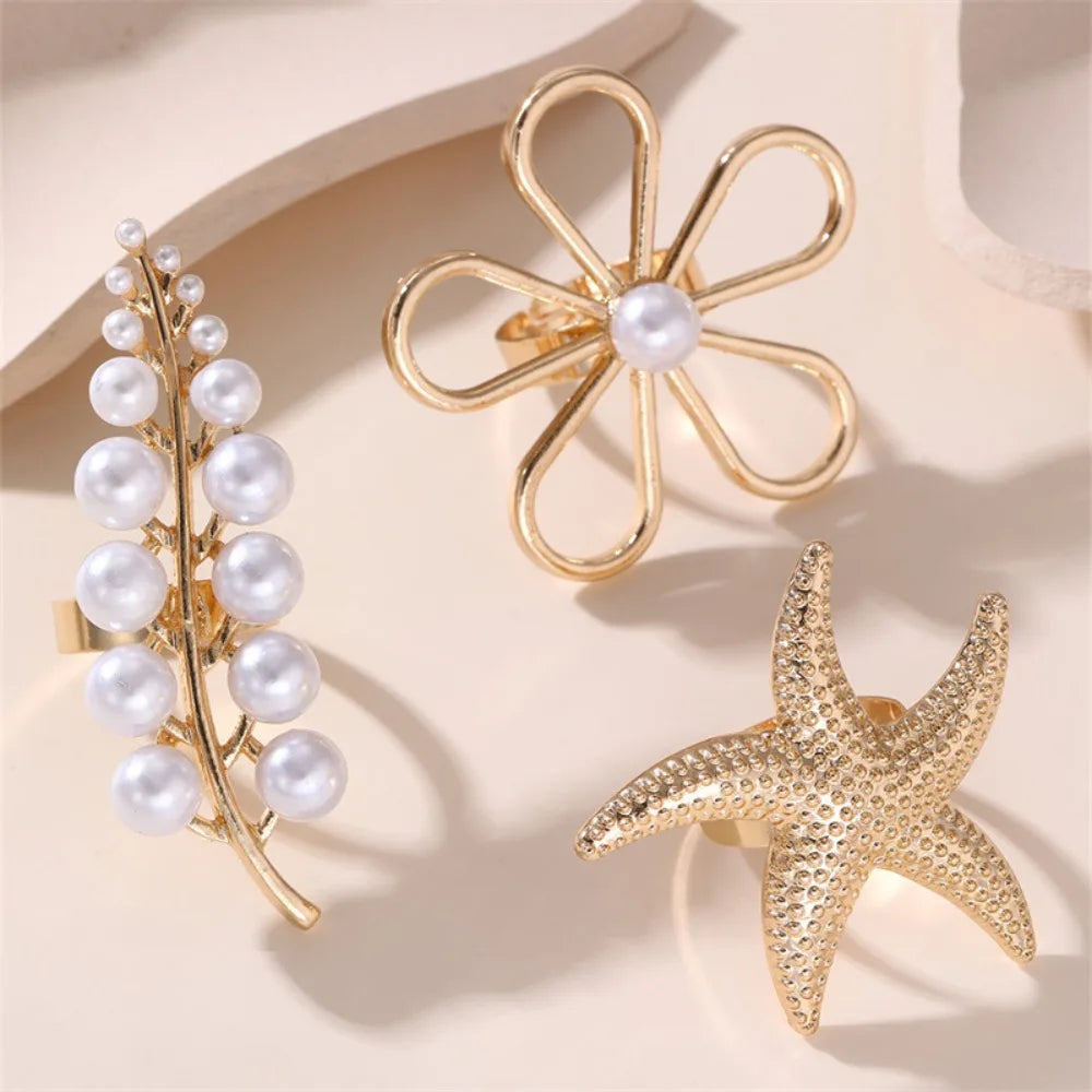 Gold-tone starfish pearl ring with white pearl center and scalloped loops