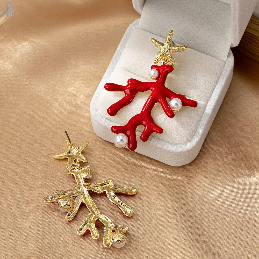 Red coral starfish earrings with gold-tone sea stars and pearl-like bead details in box