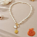 White shell-link pendant necklace with gold-tone conch charms and small white shells