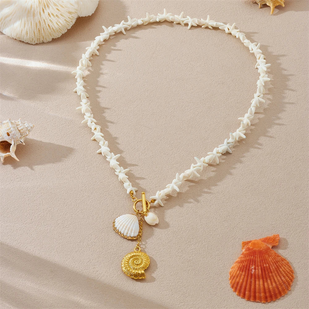 White shell-link pendant necklace with gold-tone conch charms and small white shells