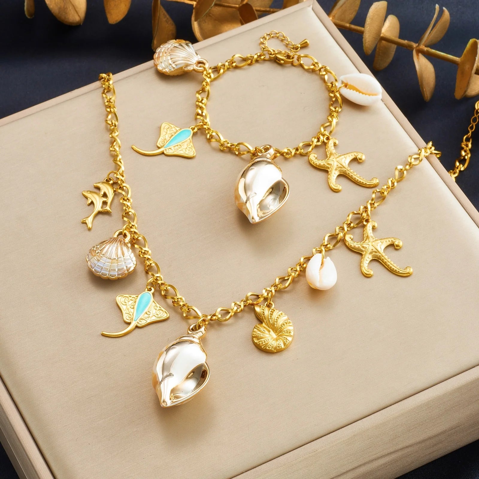 Gold-tone multi-pendant ocean necklace with starfish, conch shell, and seahorse charms