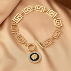 Gold embossed chain anklet with Greek-key links and round lion medallion charm