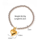 Beaded heart bracelet with gold heart charm on silver-toned ball chain