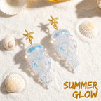 Gold starfish jellyfish drop earrings with iridescent clear jelly charms.