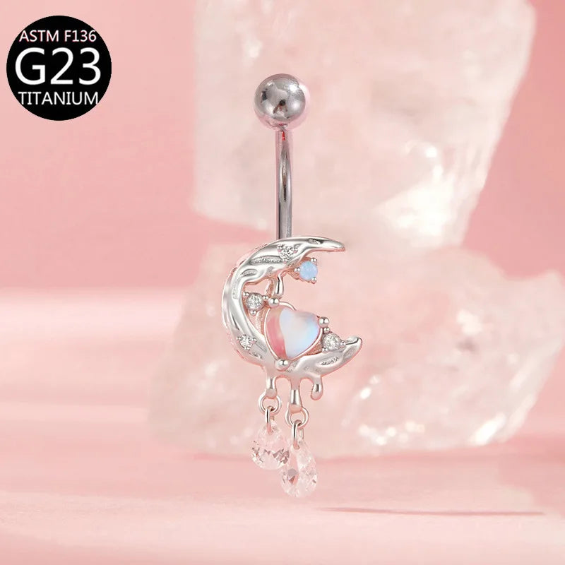 Curved barbell navel ring with crescent moon design, opal heart, and crystal drop charms