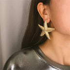 Boucles d'oreilles pendantes bohème à pompons — Étoile de mer et coquillage