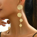 Gold-tone woven disc dangle earrings with four hanging circles and long tassel drops