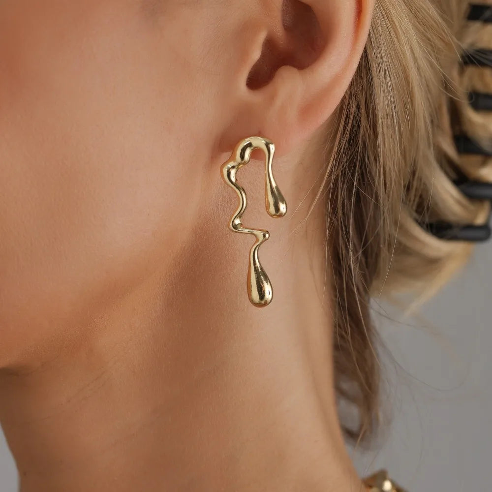 Gold-tone lava-drop dangling earrings with sculpted teardrop shapes