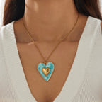 Gold chain necklace with blue enamel heart pendant and gold inner heart