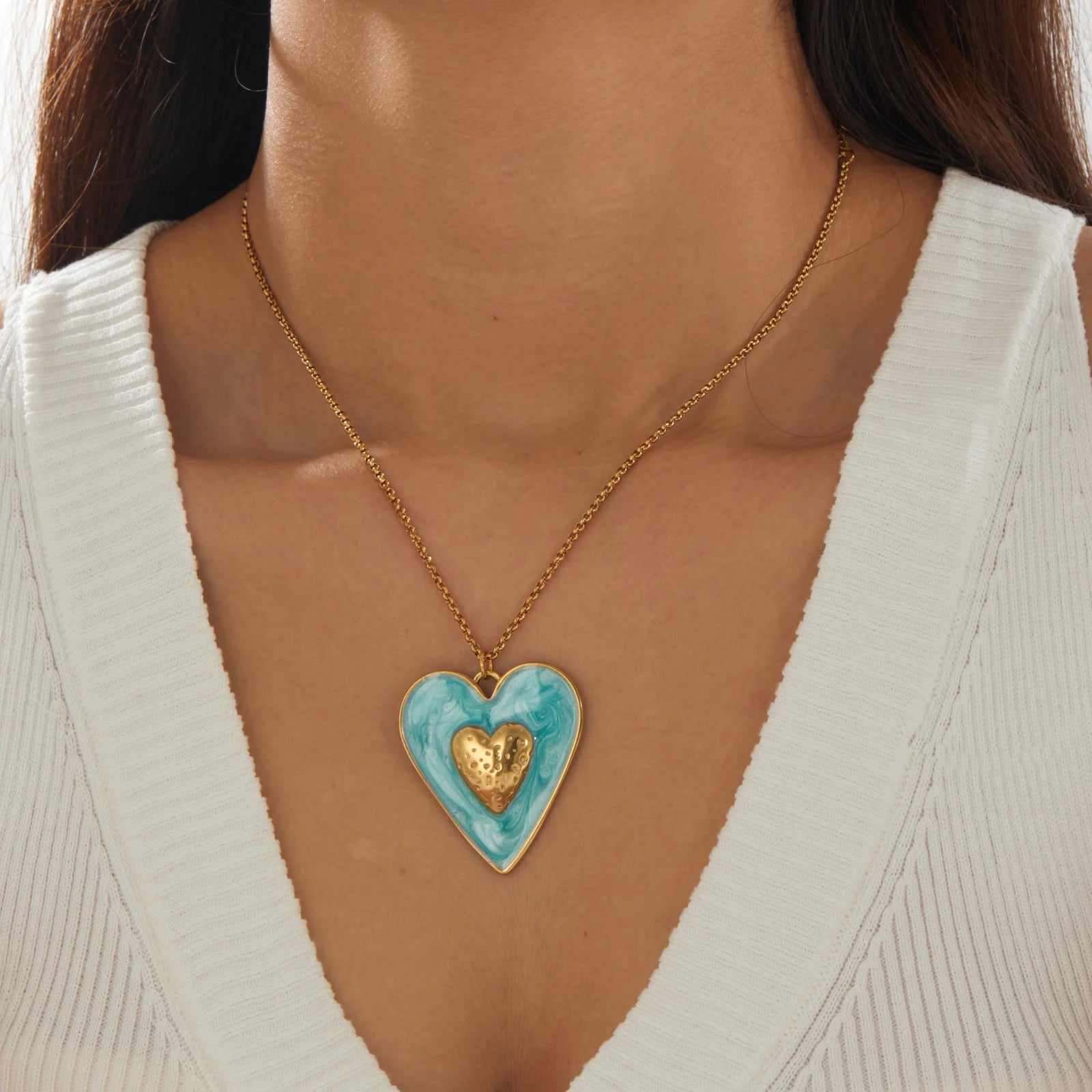 Gold chain necklace with blue enamel heart pendant and gold inner heart