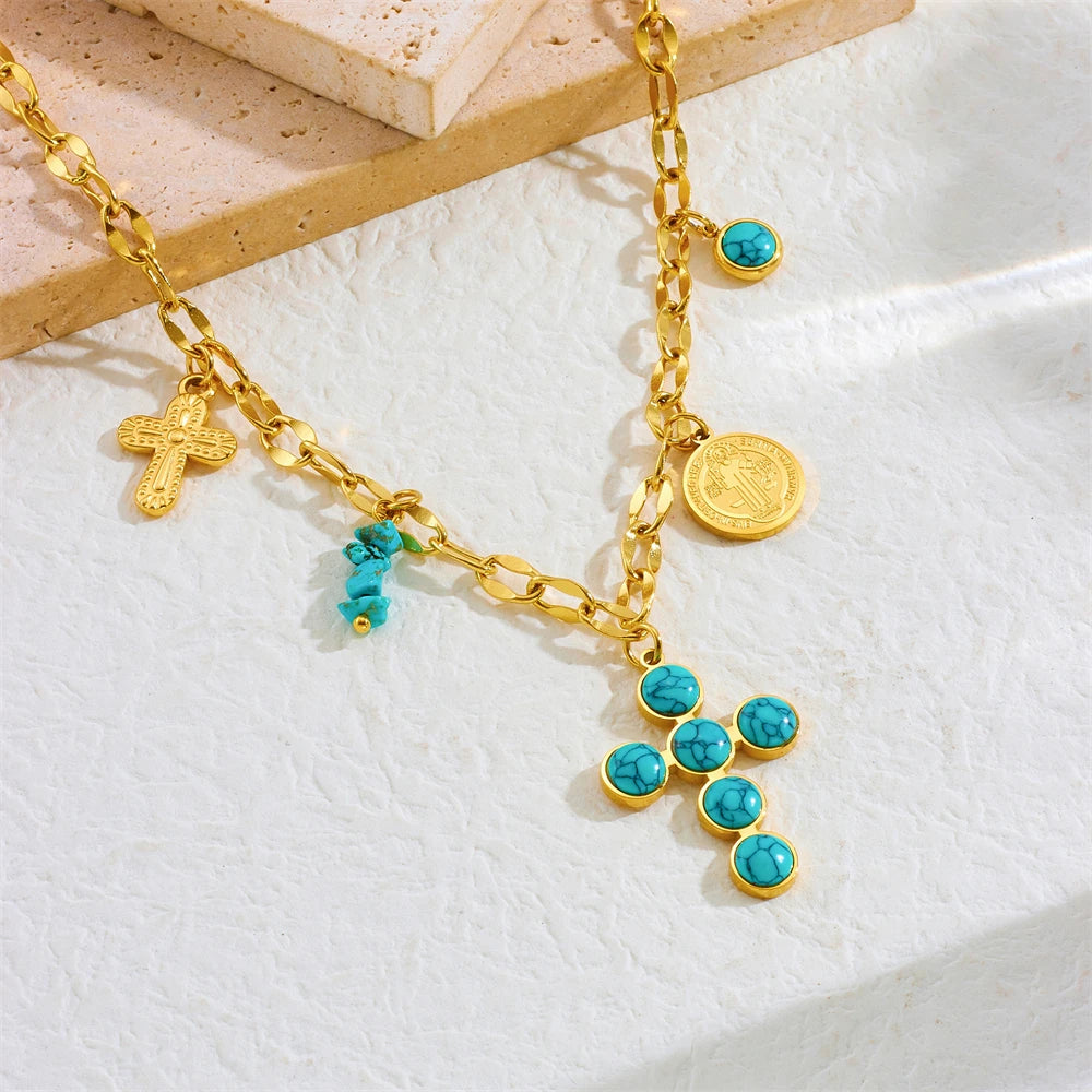 Gold-tone cross pendant necklace with turquoise bead cross and coin charm