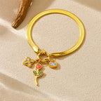 Gold-tone snake bracelet with rose, heart, and red flower charms