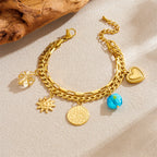 Gold-tone layered chain bracelet with sun and heart charms, coin and turquoise beads