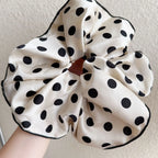 White cotton polka-dot scrunchie with black dots, gathered circular bow